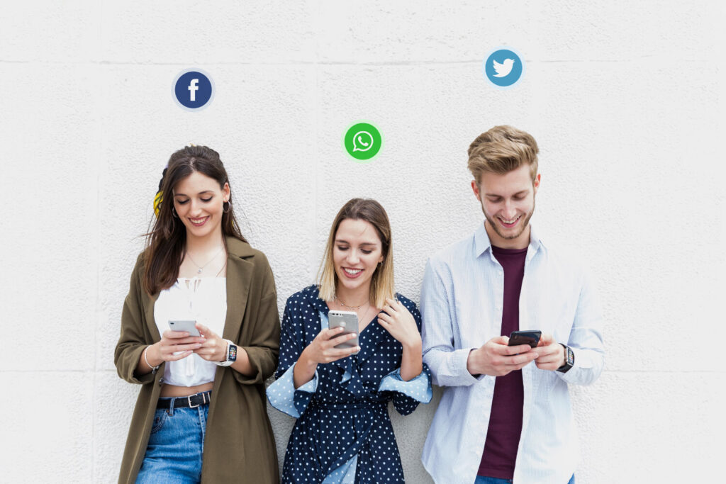 Three young people using different social media websites on their mobile phone