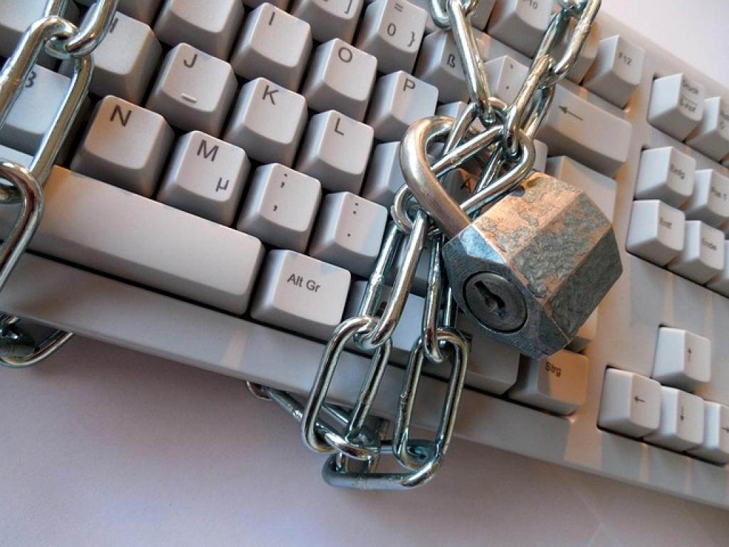 a padlock and chain on a keyboard