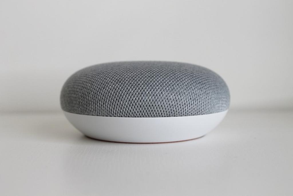 Small gray smart speaker on surface