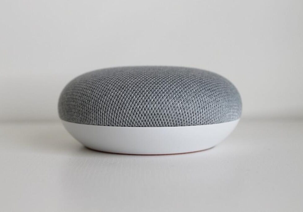 Small gray smart speaker on surface
