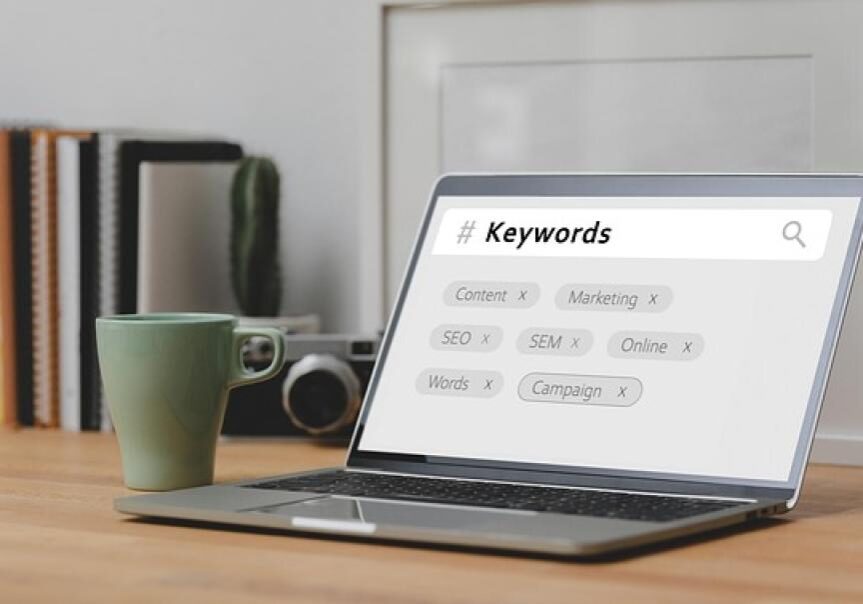 Laptop displaying keywords for marketing